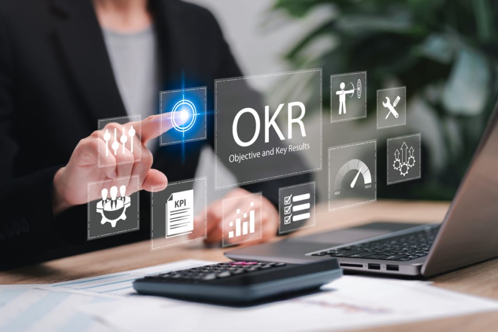 Faceless woman using computer calculating goals with OKR