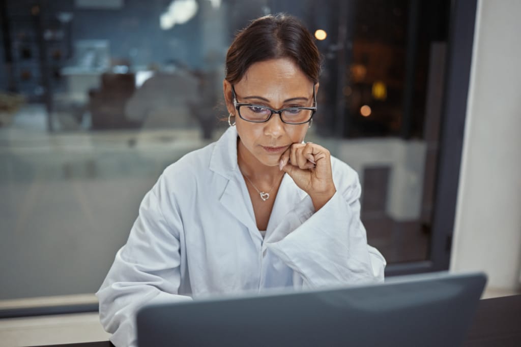 Female physician learning how to use AI tools at her medical practice